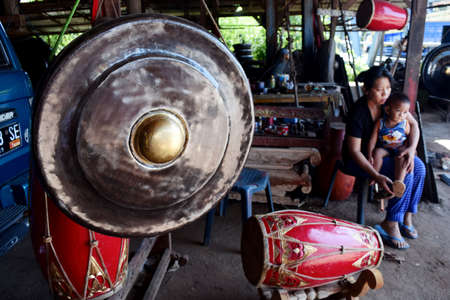 A worker completing the manufacture gamelan at home industry in Paju village, Ponorogo, East Java, Indonesia.のeditorial素材