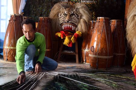 A craftsman makes reyog handicrafts village Ngampel, Balong, Ponorogo, East Java, Indonesiaのeditorial素材