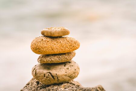 Pile of stones on the beach with a blur background