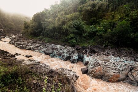 Rocky river during morning mistの写真素材