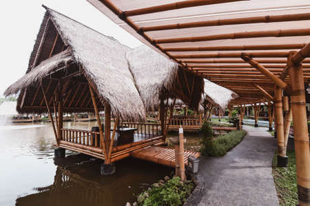 Surabaya, Indonesia - March 28, 2019: The atmosphere inside of the restaurant, the building made by bamboo above the fish pond named Gubug Makan Mang Eking, at Juanda Surabaya, East Java, Indonesiaのeditorial素材