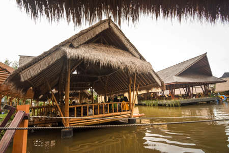 Surabaya, Indonesia - March 28, 2019: The atmosphere inside of the restaurant, the building made by bamboo above the fish pond named Gubug Makan Mang Eking, at Juanda Surabaya, East Java, Indonesiaのeditorial素材
