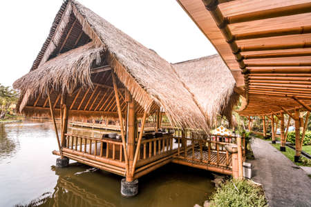 Surabaya, Indonesia - March 28, 2019: The atmosphere inside of the restaurant, the building made by bamboo above the fish pond named Gubug Makan Mang Eking, at Juanda Surabaya, East Java, Indonesiaのeditorial素材