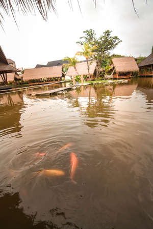 Surabaya, Indonesia - March 28, 2019: The atmosphere inside of the restaurant, the building made by bamboo above the fish pond named Gubug Makan Mang Eking, at Juanda Surabaya, East Java, Indonesiaのeditorial素材