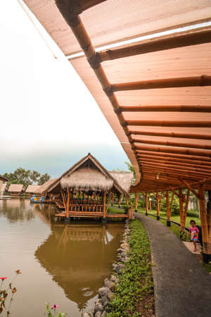 Surabaya, Indonesia - March 28, 2019: The atmosphere inside of the restaurant, the building made by bamboo above the fish pond named Gubug Makan Mang Eking, at Juanda Surabaya, East Java, Indonesiaのeditorial素材