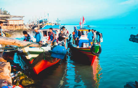 Pandeglang, Indonesia - July 24, 2019: The busyness of the fishermen preparing to move the results of fishing in the traditional port of Panimbang Village, Pandeglang, Banten Province, Indonesiaのeditorial素材