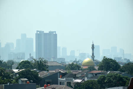 High rise buildings in Jakarta continue to grow while settlements are left out, as the metropolitan city of Jakarta, the capital of Indonesia on July 25, 2019のeditorial素材