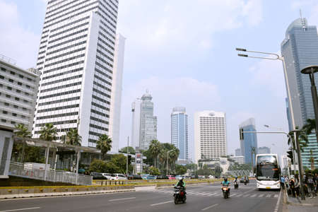 Jakarta, Indonesia - July 25, 2019: Traffic on the road in Central Jakarta during the day around the Hotel Indonesia (Bundaran HI)のeditorial素材