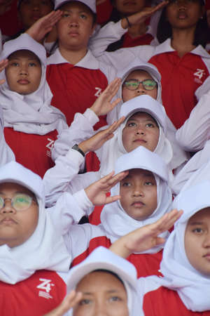 Surbaya, Indonesia - August 17, 2019: Students sing the Indonesian struggle again at the 74th Indonesian Independence Ceremony at the Grahadi Building in Surabaya, East Java, Indonesiaのeditorial素材
