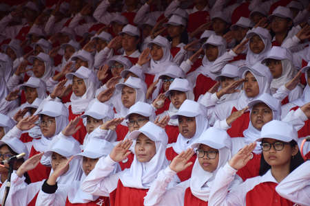 Surbaya, Indonesia - August 17, 2019: Students sing the Indonesian struggle again at the 74th Indonesian Independence Ceremony at the Grahadi Building in Surabaya, East Java, Indonesiaのeditorial素材