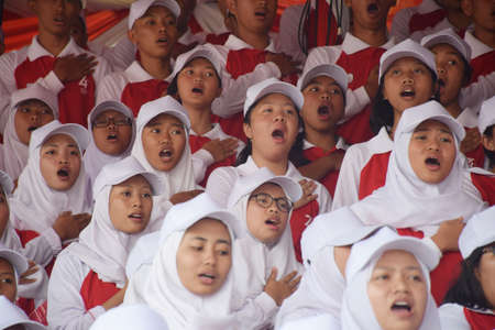 Surbaya, Indonesia - August 17, 2019: Students sing the Indonesian struggle again at the 74th Indonesian Independence Ceremony at the Grahadi Building in Surabaya, East Java, Indonesiaのeditorial素材