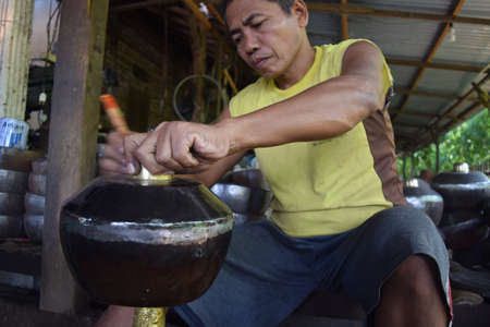 A worker completing the manufacture gamelan at home industry in Paju village, Ponorogo, East Java,...