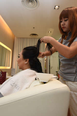 Surabaya, Indonesia - October 06, 2016: A model doing hair care at the famous salon Galaxy Mall Surabaya, East Java, Indonesiaのeditorial素材