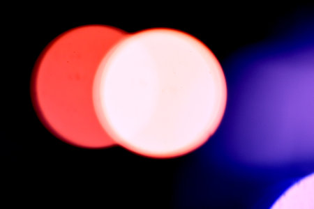 Abstract circular bokeh background, defocused lights on black background