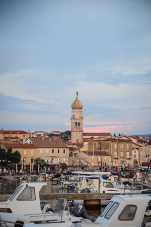 Croatian town with a church tower. Beautiful sunset in the town.の写真素材