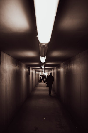 Silhouette of a man walking in a tunnel.の写真素材