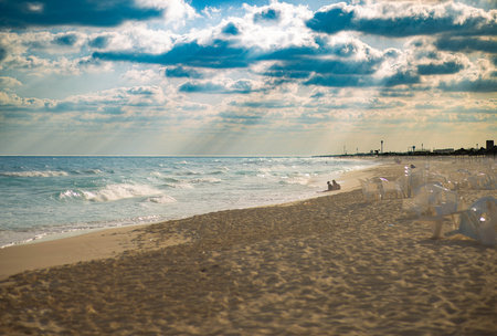 Beautiful sunset on the beach with sunbeams and clouds.の写真素材