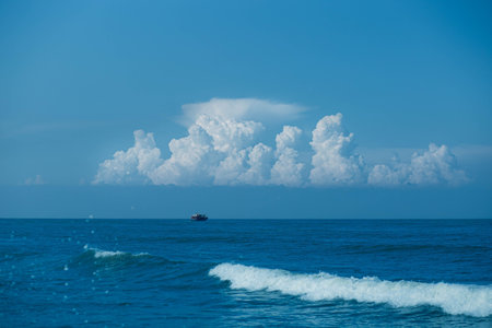 Beautiful seascape with blue sky, white clouds and boatの写真素材