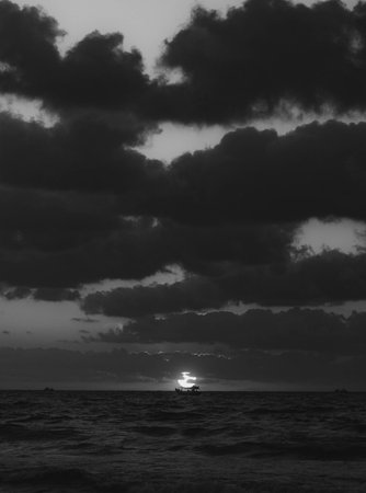 Beautiful sunset on the sea. Black and white photo of the sea.の写真素材