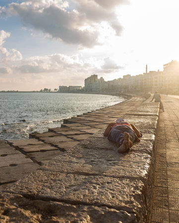 Man sleeping on the corniche in Alexandriaの写真素材