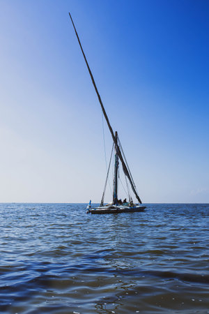 Sailing boat in the sea on a background of blue sky.の写真素材