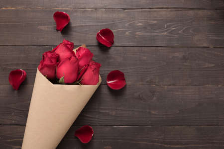Red roses flower are on the wooden background.の写真素材