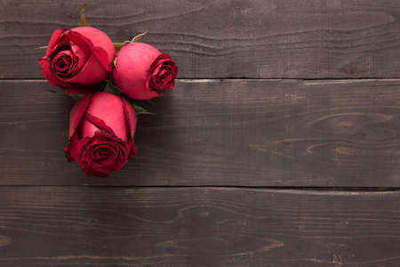 Beautiful red rose flower are on the wooden background.の写真素材