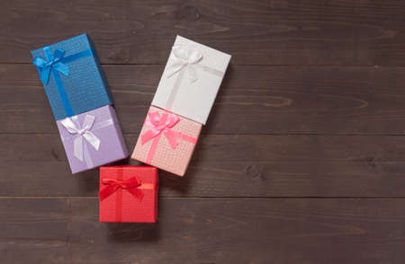 Gift boxes are on the wooden background with empty space.の写真素材