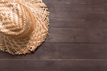 Brown hat is on the wooden background.の写真素材