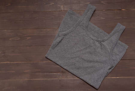 Gray vest is on the wooden background.の写真素材