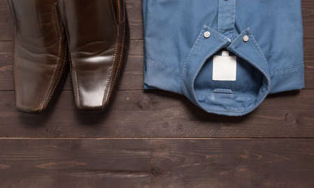 Shoes and menswear are on the wooden background.の写真素材