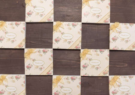 Notebooks with thank you message are on the wooden background.