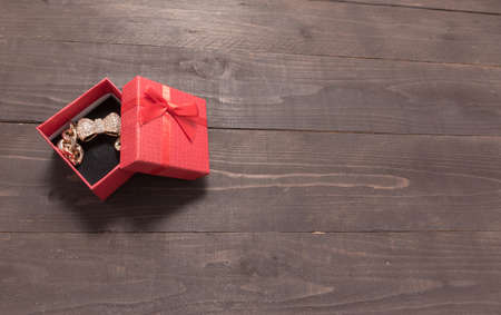 Red gift box is on the wooden background with empty space.の写真素材