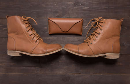 Traditional leather cowboy boots are on the wooden background.の写真素材