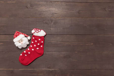 Red sock and santa on the wooden background with empty space.の写真素材