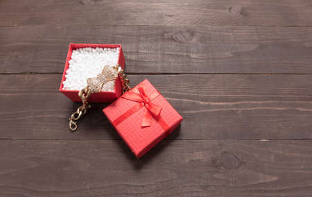 Red gift box is on the wooden background with empty space.の写真素材