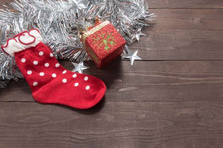 Red sock and gift are on the wooden background with empty space for Christmas day.の写真素材