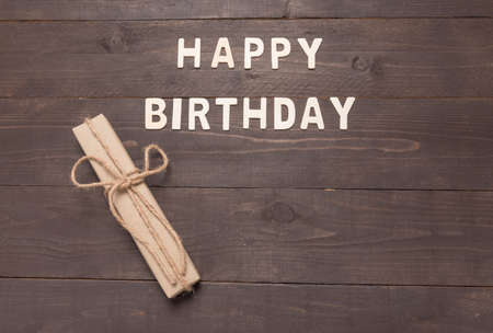Happy Birthday and gift box on wooden background with copy space.の写真素材