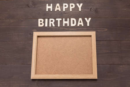 Happy Birthday and frame picture on wooden background with copy space.の写真素材