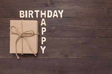 Happy Birthday and gift box on wooden background with copy space.の写真素材