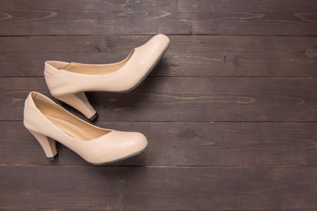 High heels are on wooden background with copy space.の写真素材