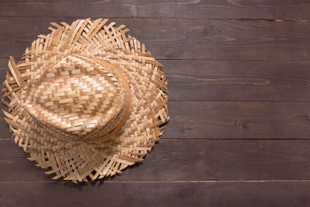 Brown hat is on the wooden background.の写真素材