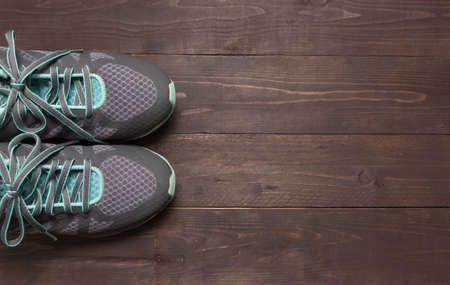 Sneakers is on the wooden background.