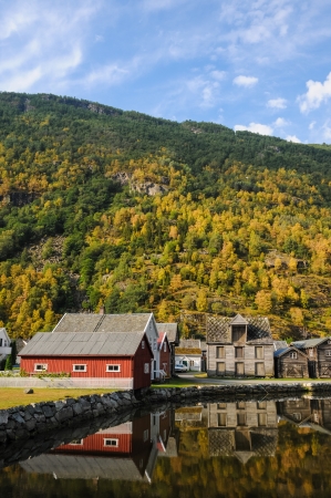 Reflections of houses in the waters of a fjord in Norwayの写真素材