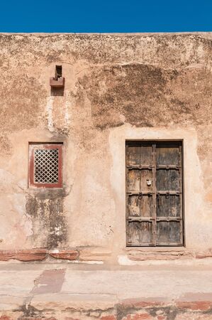 Residential building with wooden doors and windows against a blue skyの写真素材