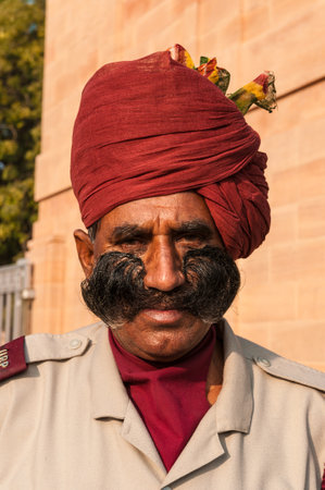 An Indian man in uniform with a beautiful mustache and red turbans in Rajasthan, Indiaのeditorial素材