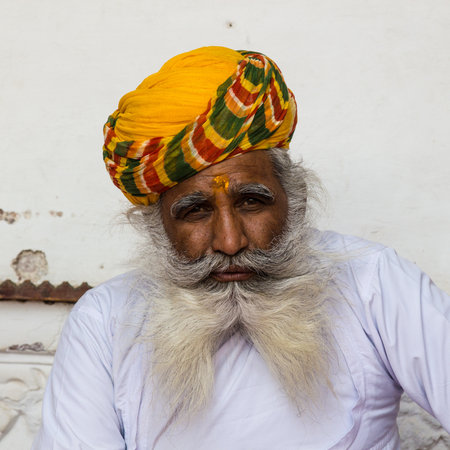 An old Indian man with a beautiful beard and yellow turban, Rajasthan, Indiaのeditorial素材