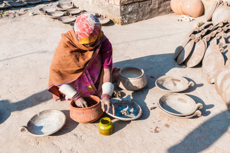 An Indian woman who painted pots in a pottery, Indiaのeditorial素材
