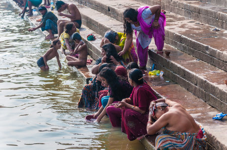 Indian people wash themselves in the river Ganges in Varanasi, Indiaのeditorial素材