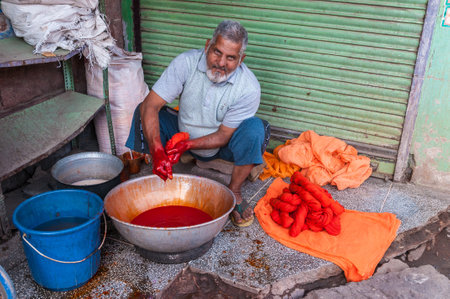 Indian man dyed fabrics in red, Jodhpur, Rajasthan, India のeditorial素材